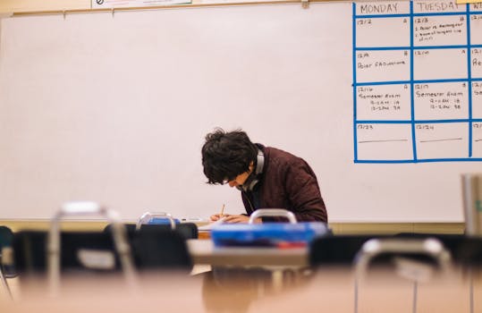 pexels-photo-3380743-3380743 A high school student studying and solving problems in a classroom setting.